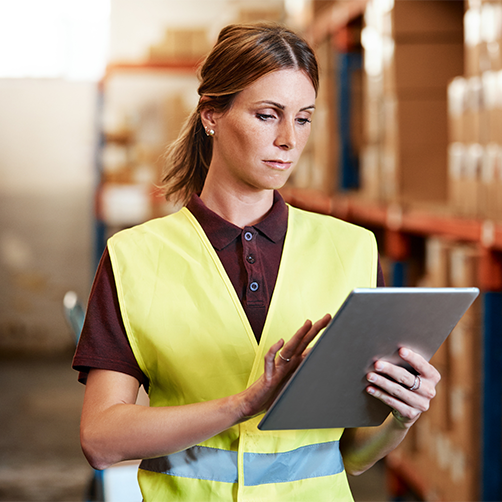 woman looking at tablet in warehouse