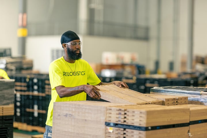 Relogistics employee processing material