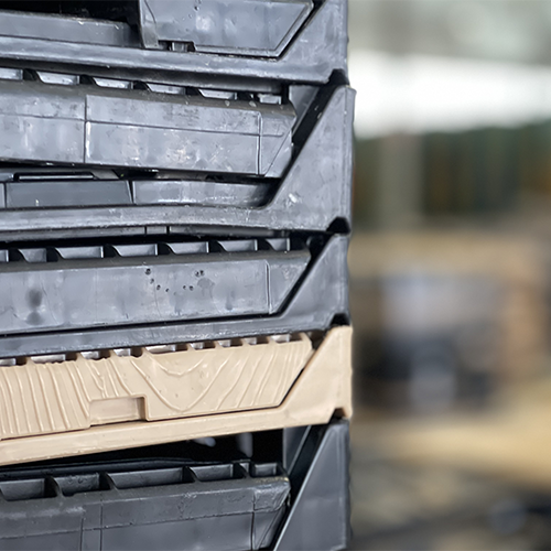 Stacked reusable plastic containers in a warehouse setting, showcasing container management solutions for efficient supply chain handling.