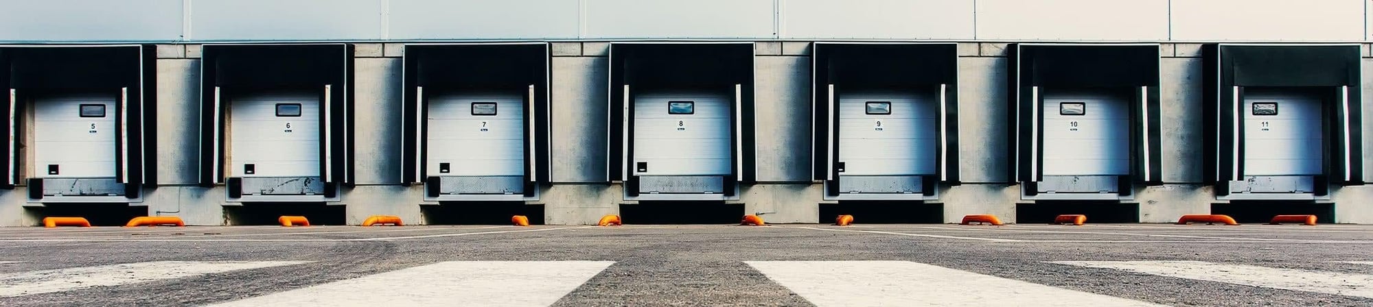 Loading dock bays with numbered doors for efficient trailer unloading and logistics management. Loading dock bays with numbered doors for efficient trailer unloading and logistics management.