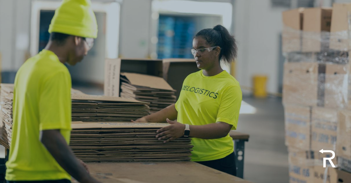 Two employees in bright yellow shirts working together in a warehouse, efficiently managing break pack boxes, highlighting Relogistics' commitment to effective pallet management and supply chain solutions.